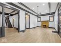 Large living room with hardwood floors, fireplace, and decorative molding at 3752 Ruckle St, Indianapolis, IN 46205