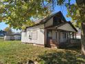 A fixer-upper house needing renovation, located on a grassy lot at 5105 W Legrande Ave, Indianapolis, IN 46241