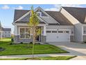 Gray siding craftsman style home with two-car garage and stone accents at 10549 Maidenhair Dr, Indianapolis, IN 46239