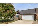 White garage door and brick front of charming ranch home at 1202 Creek Bend Dr, Greenwood, IN 46143