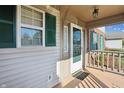 Front porch with green shutters and door at 9620 Claymore Dr, Fishers, IN 46038