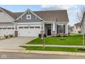 Ranch home with gray siding, white trim, and a two-car garage at 10612 Maidenhair Dr, Indianapolis, IN 46239