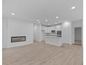 Open concept kitchen with white cabinets, stainless steel appliances, and an island at 10612 Maidenhair Dr, Indianapolis, IN 46239