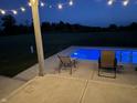 Relaxing poolside view with patio chairs at night at 3503 W 100 N, Bargersville, IN 46106
