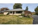 Ranch house with stone facade, attached garage, and a spacious yard at 2620 Wicker Rd, Indianapolis, IN 46217