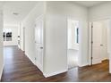 Light and airy hallway with wood-look floors and white doors at 7171 Rose Hill Ave, Brownsburg, IN 46112