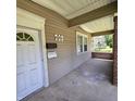 Front porch with brick columns and a white door at 709 W Riverside Ave, Muncie, IN 47303