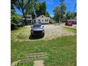 Gravel parking area with grassy areas and a truck at 709 W Riverside Ave, Muncie, IN 47303