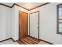 Simple entryway with wood flooring, white walls, and a coat closet at 521 Eagle Crest Dr, Brownsburg, IN 46112