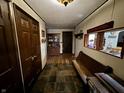 Inviting entryway with a built-in bench and view of the kitchen at 8353 N Sr 109, Wilkinson, IN 46186