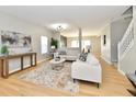 Bright living room with comfy sofas, coffee table, and hardwood floors at 6919 Wilmot Ln, Avon, IN 46123