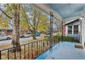 Quaint front porch with decorative railing and view of street at 2028 Hoyt Ave, Indianapolis, IN 46203