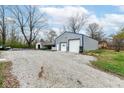 Large detached garage with double doors and gravel driveway at 5034 E Orchard Rd, Mooresville, IN 46158