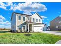 Two-story house with taupe siding, white trim, and a three-car garage at 5856 Fair Oak Cir, Brownsburg, IN 46112