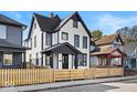 White house with black accents and a wood fence at 631 Cottage Ave, Indianapolis, IN 46203
