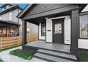 Front porch with concrete flooring and black columns at 631 Cottage Ave, Indianapolis, IN 46203
