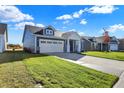 Two-story home with blue siding, white trim, and a two-car garage at 7149 Rose Hill Ave, Brownsburg, IN 46112