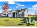 Ranch-style home with blue siding, white trim, and a two-car garage at 7149 Rose Hill Ave, Brownsburg, IN 46112