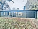 Ranch house with a black painted brick exterior, attached garage, and neatly kept lawn at 2442 N Franklin Rd, Indianapolis, IN 46219