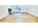 Bright living room with hardwood floors, a fireplace, and a view of the street at 2442 N Franklin Rd, Indianapolis, IN 46219