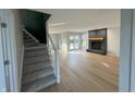 Living room features hardwood floors, a fireplace, and access to a patio at 2413 Griton Ct, Shelbyville, IN 46176