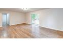Bright and airy living room featuring hardwood floors and sliding glass doors at 6423 Verbena Ct, Indianapolis, IN 46224