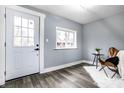Bright entryway with a white door and gray walls, featuring hardwood floors at 1621 Draper St, Indianapolis, IN 46203
