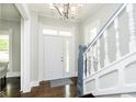 Bright entryway with staircase, hardwood floors, and chandelier at 408 W 11Th St, Anderson, IN 46016