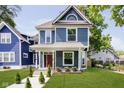 Beautiful blue two-story home with a well-manicured lawn at 408 W 11Th St, Anderson, IN 46016