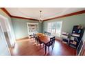 Formal dining room with hardwood floors and large window at 1160 Mt Vernon Dr, Greenwood, IN 46142