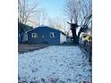 Large gravel backyard with a gray house in the background at 1601 Draper St, Indianapolis, IN 46203