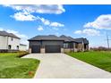 Three-car garage with modern doors and ample driveway parking at 5035 Abington Way, Zionsville, IN 46077