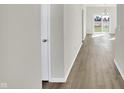 Long hallway with light gray walls and wood-look flooring at 7139 Rose Hill Ave, Brownsburg, IN 46112