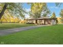 House exterior showcasing a large yard and driveway at 908 Sprague St, Indianapolis, IN 46217