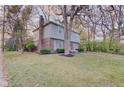 Side view of a two-story house with brick and siding, and mature trees at 4902 N Capitol Ave, Indianapolis, IN 46208