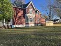 Side view of the house showing a large deck, and well-manicured lawn at 503 E Clyde St, Frankton, IN 46044