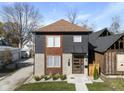 Modern two-story home with gray and wood siding, landscaping, and a walkway at 1514 E 12Th St, Indianapolis, IN 46201