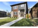Modern two-story home with gray and wood siding, landscaping, and a walkway at 1514 E 12Th St, Indianapolis, IN 46201