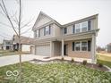 Two-story house with gray siding, brick accents, and a three-car garage at 259 Lar Lan Dr, Danville, IN 46122