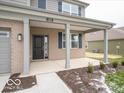 Covered front porch with brick columns and a black front door at 259 Lar Lan Dr, Danville, IN 46122