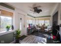 Bright sunroom with hardwood floors and a ceiling fan at 3136 E Edgewood Ave, Indianapolis, IN 46227