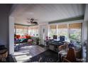 Sunroom features hardwood floors, a ceiling fan, and ample natural light at 3136 E Edgewood Ave, Indianapolis, IN 46227