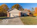 Brick ranch home with attached garage and autumn trees at 304 Chestnut St, Danville, IN 46122