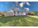 Gray ranch home with a fenced yard and attached garage at 5323 Padre Ln, Indianapolis, IN 46237