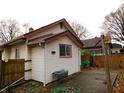 Side view of a house with white siding, and a wooden fence at 821 N Tuxedo St, Indianapolis, IN 46201