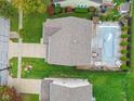 Aerial view showing a house with a pool and surrounding landscaping at 1285 Greenwood Station Blvd, Greenwood, IN 46143