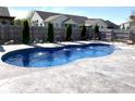 Relaxing inground pool with water features in a backyard setting at 1285 Greenwood Station Blvd, Greenwood, IN 46143