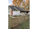 White house needing repairs, with chain link fence at 1656 Nelson Ave, Indianapolis, IN 46203