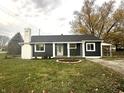 Updated ranch home with dark siding, white accents, and a landscaped front yard at 1902 Silver St, Anderson, IN 46012