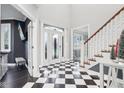Two-story foyer with checkerboard floor and elegant staircase at 5784 N 600 E, Greenfield, IN 46140